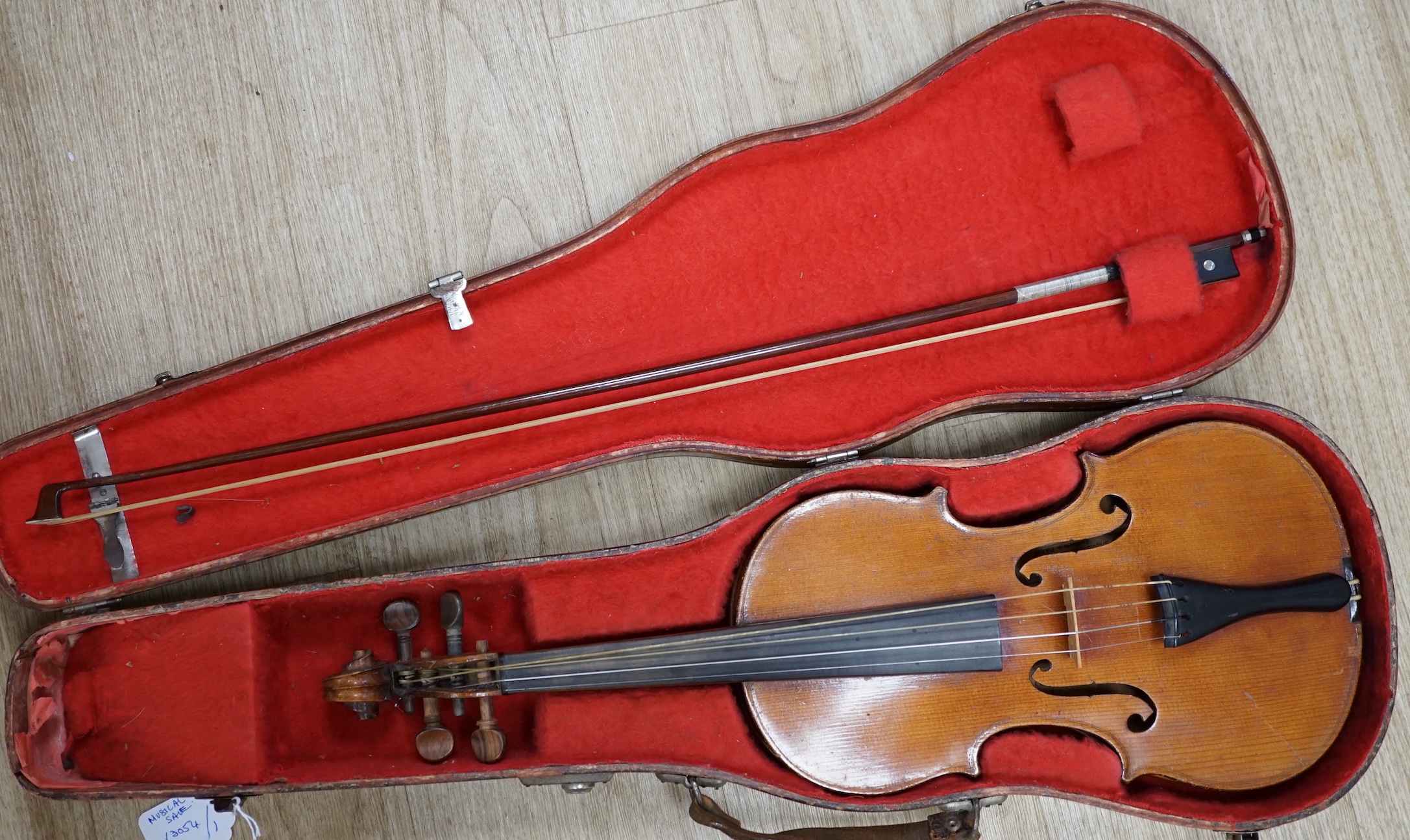 A cased early 20th century French violin and bow, label inside for Jerome Thibouville-Lamy, body length 36cm CITES Submission reference 5URFZXWK